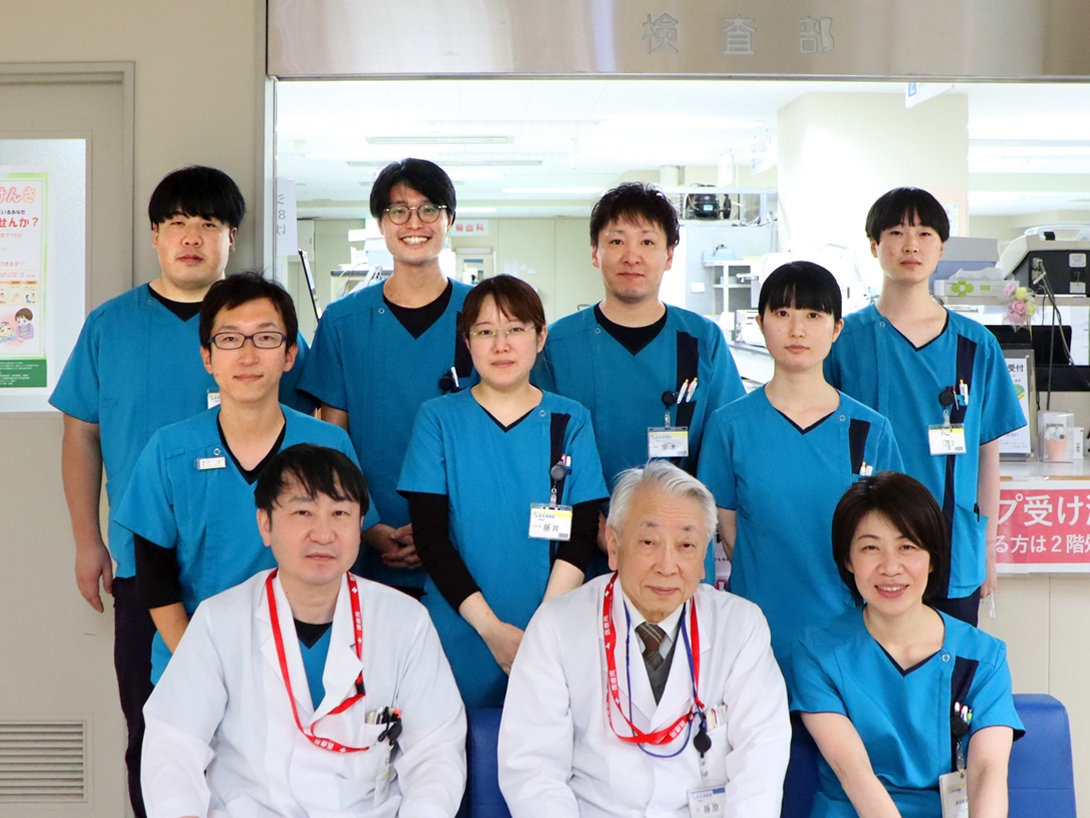 検査部のみなさん（前列左から）能美伸太郎技師長、藤原謙太部長、松本係長。（2列目左）森實係長